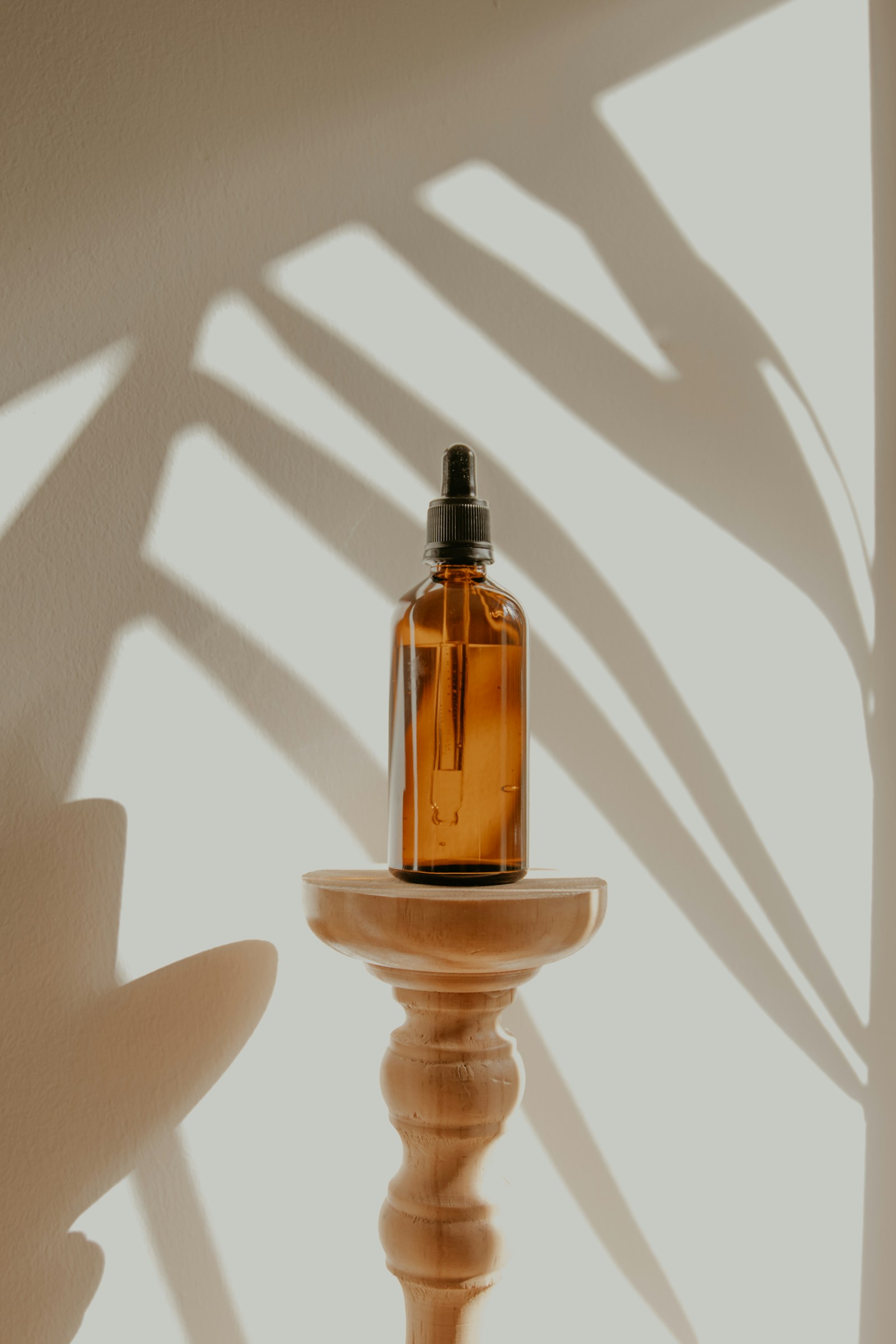 An amber skincare bottle in natural light