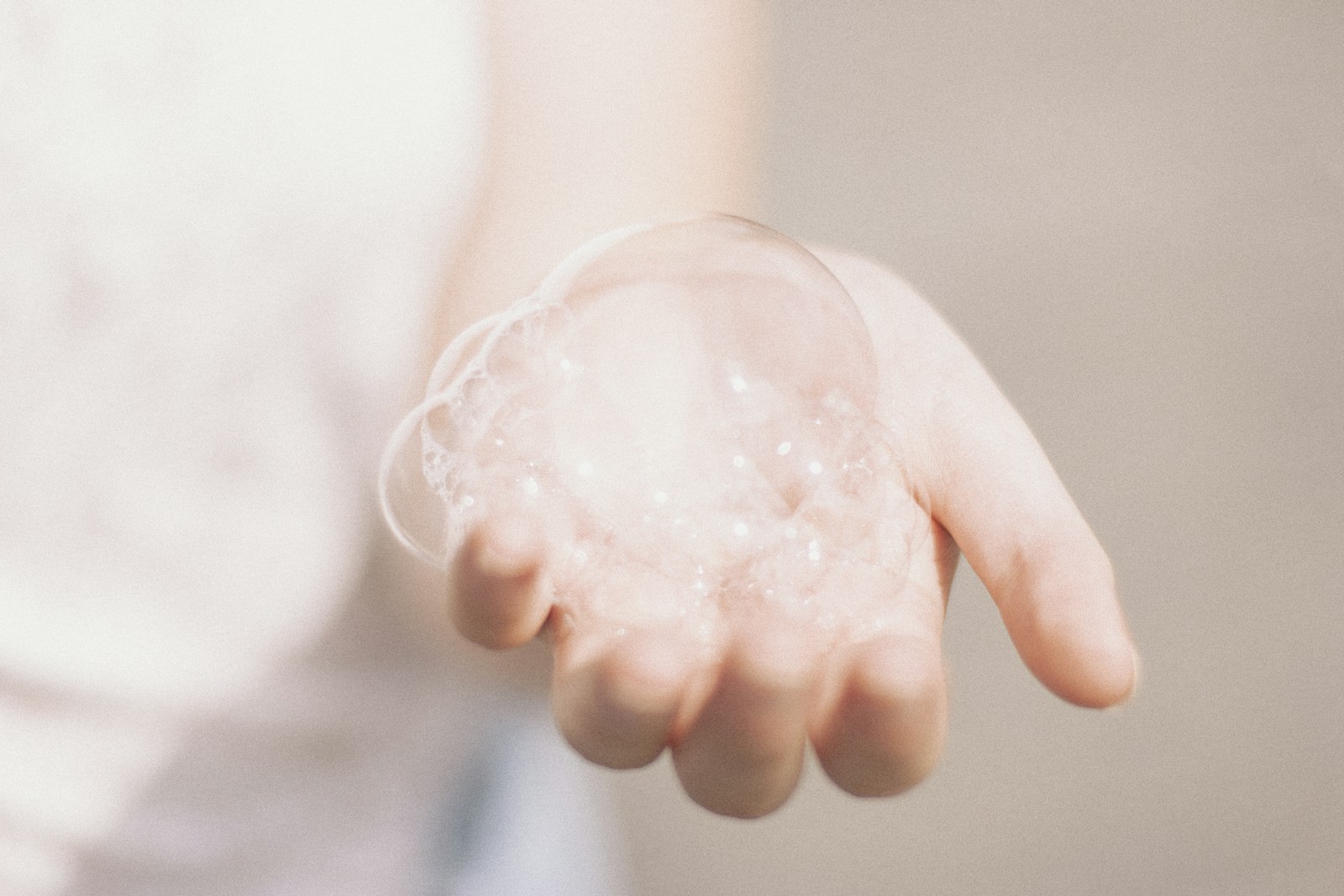 Soft cleansing bubbles held in a hand