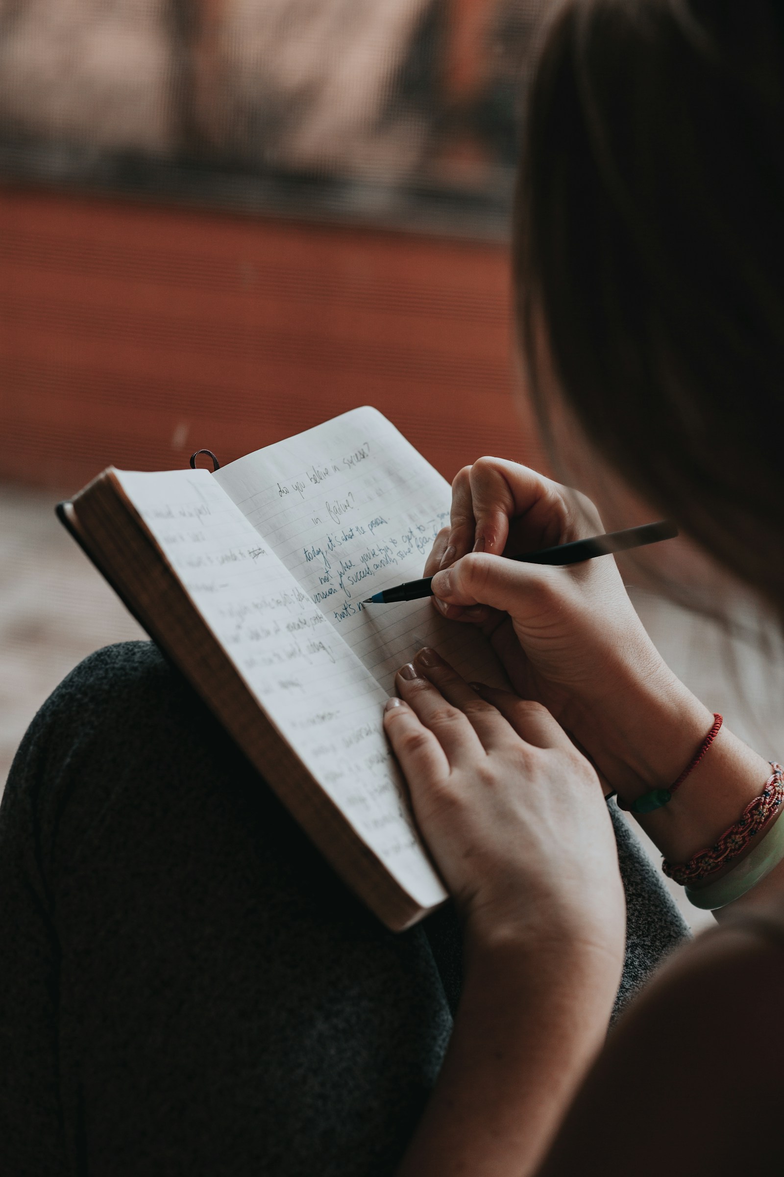 A person writing in a notebook