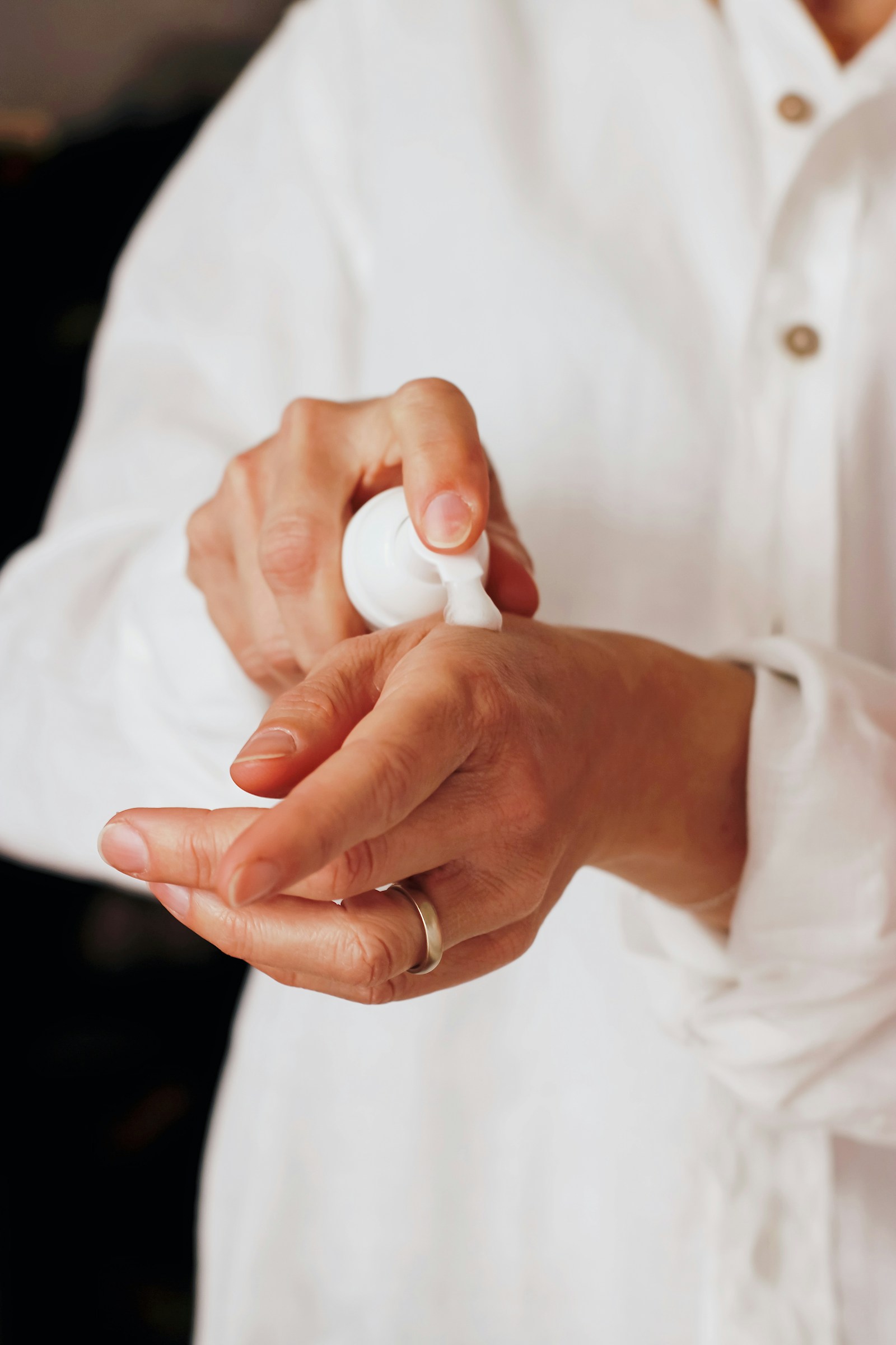 Hands applying skincare