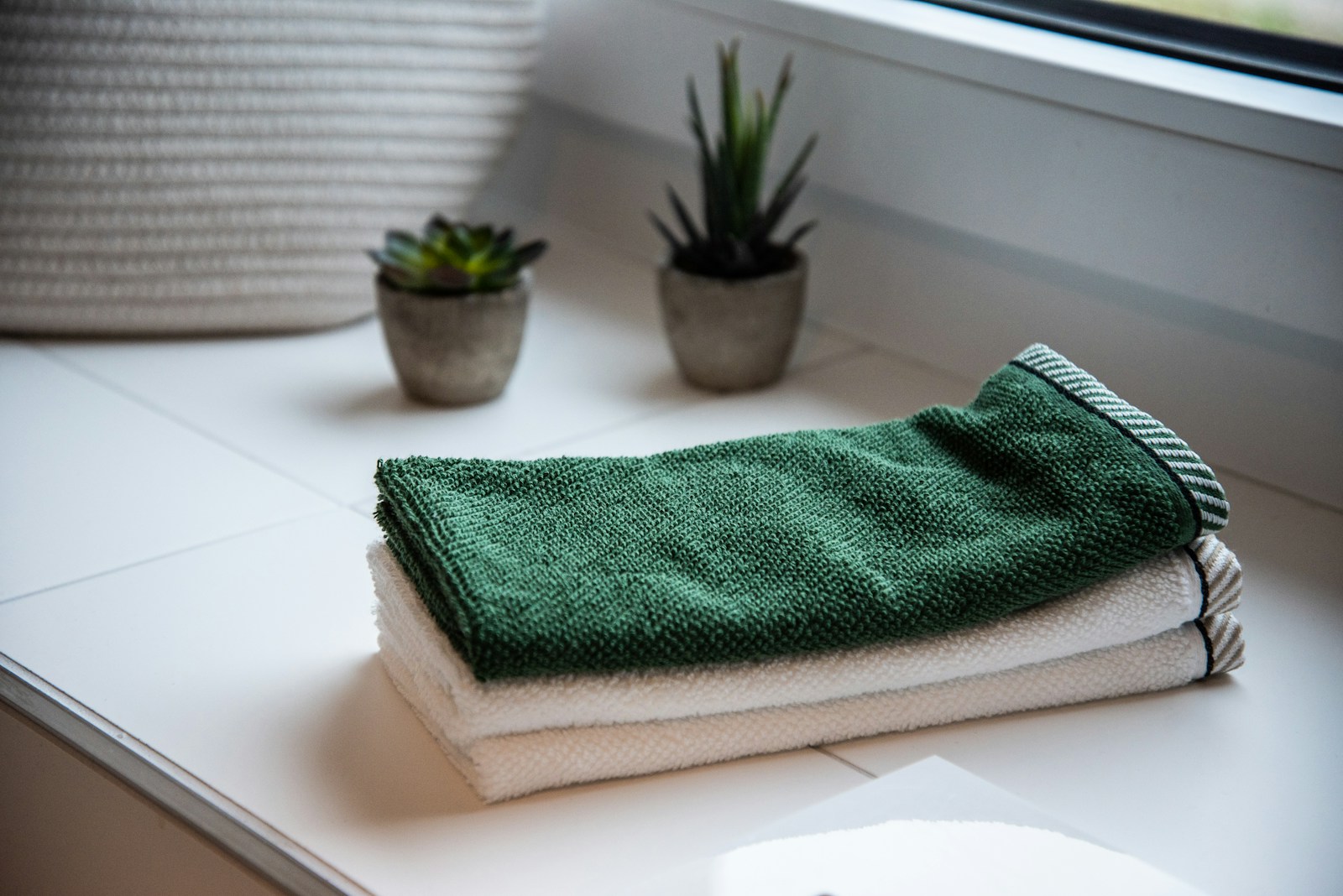 Fresh towels beside a washbasin